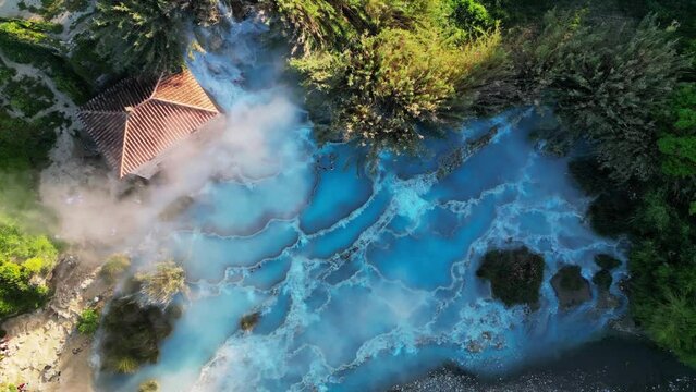 Aerial view of a beautiful turquoise waters of natural spa. Morning atmosphere at the popular hot springs Saturnia, Tuscany, Italy.