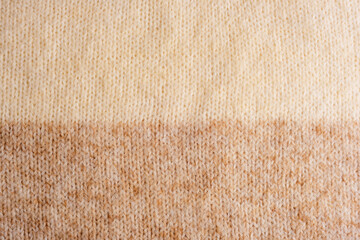 Beige and brown woolen knitted sweater fabric, texture, background - obrazy, fototapety, plakaty