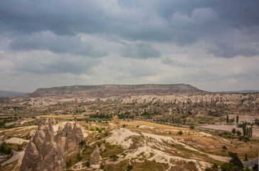 Rocky landscape in Cappadocia, Turkey. Travel in Cappadocia. Unusual semi-desert mountain ranges. Amazing Rocky summer landscape in Cappadocia Goreme