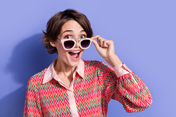 Photo of overjoyed ecstatic woman dressed print shirt touching glasses staring at discount open mouth isolated on blue color background