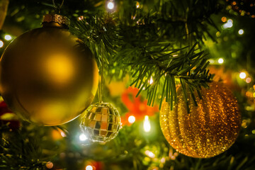 Holiday season. cClose view of baubles and light bulbs on a Christmas tree