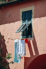 Fototapeta na wymiar Laundry is dried outside a window in the center of Ventimiglia in Italy.