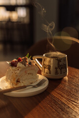 Piece of meringue roll with raspberries in a white plate.