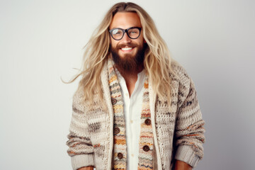 Portrait of a handsome European male model wearing prescription glasses and Norwegian knitted cardigan, studio shot
