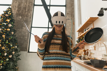  In the kitchen, a lovely young lady cooks while donning a virtual reality headset.
