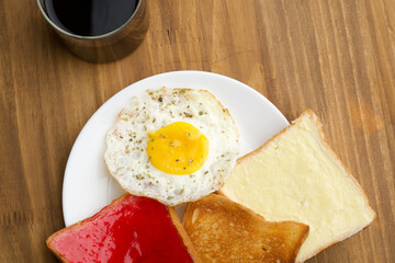 Break fast items like bread butter, bread jam, omelet and black filter coffee