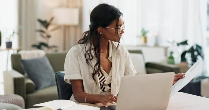 Woman, work from home and documents on computer for online research, financial planning and data report. Young worker or freelancer typing on her laptop with paperwork, bills and taxes in living room