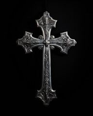 Christian symbol - silver cross isolated on black background studio light.