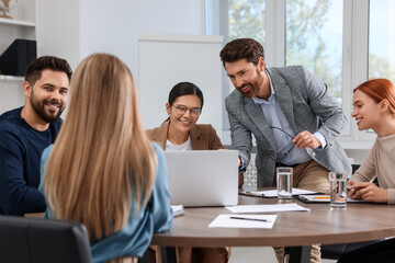 Team of employees working together in office