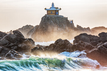 A view of the wavy winter sea. A view of winter morning at Orangdae Park in Busan, South Korea.