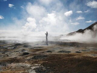geyser in park national park with person in the fog