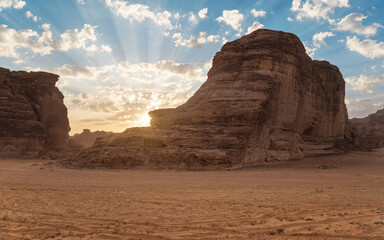 Morning sun shines over rocky desert formations, typical landscape in Al Ula, Saudi Arabia