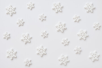 Festive pattern made of snowflakes on white background. Winter, Christmas, New Year concept.