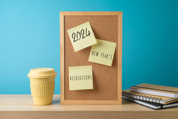 New Year 2024 resolutions business concept with memo notes, notebook and coffee cup on modern...
