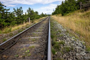 Obraz premium The famous railway line leads to the Brocken, the highest mountain in the Harz on Autumn day. A close-up of the railways. Selectively focus on the railway. 