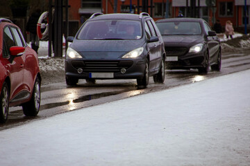 View of cars driving on city street at winter