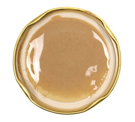 Sesame butter, paste tahini spread on jar lid isolated on white, top view
