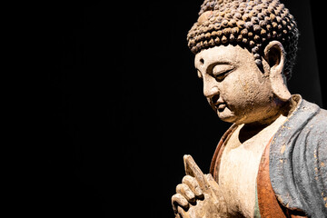 Buddha Statue - Concept of Zen, Spirituality, Peace. Copy space on Black Background
