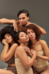 Obraz premium attractive young african american women in pastel underwear looking at camera, fashion concept