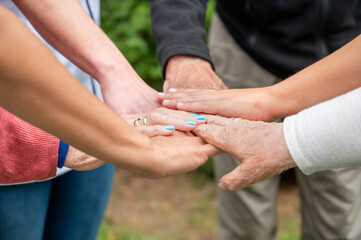 Concept of family, aging society or teamwork, hands showing unity with putting hands together,...