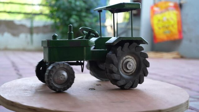 Antique red plastic toy tractor truck, 3D model of a colorful tractor - rotation video