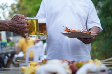 Asian, American and African family parties with grilled seafood and beer drinks, BBQ