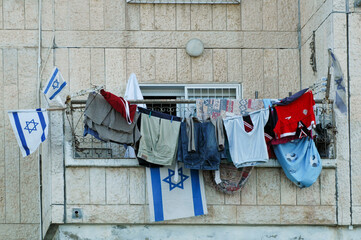 Laundry and Israeli flags on a Jerusalem balcony