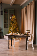 Cozy dining table in the living room with a Christmas tree