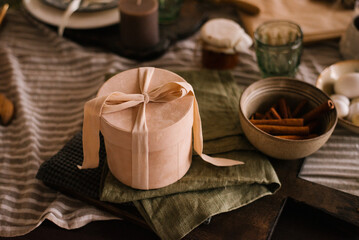 Gift box is on the dining table on a napkin