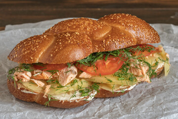 Sandwich made with challah bread, grilled salmon, boiled potato, fresh tomatoes and fennel, cream cheese.