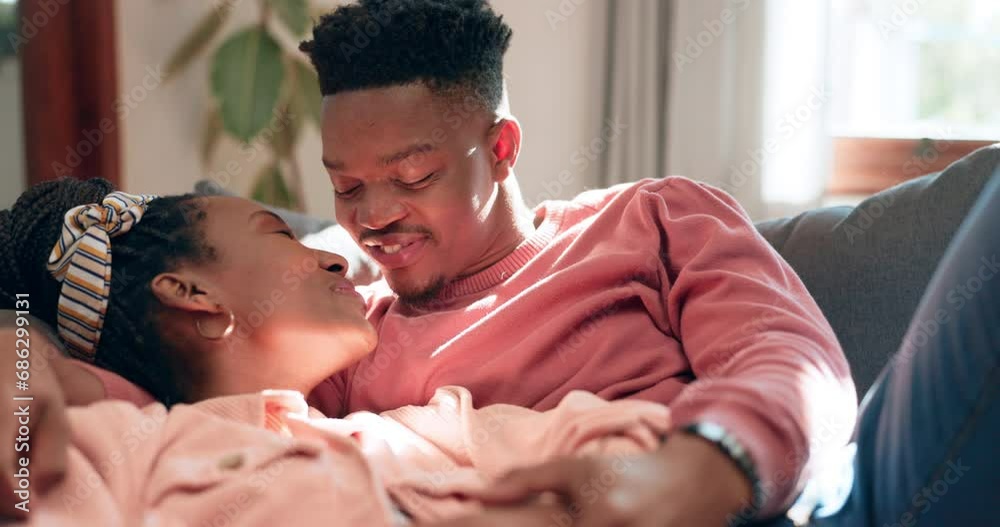 Poster Kiss, love and happy black couple relax with romantic care, support and affection for girlfriend, boyfriend or marriage partner. Smile, lounge sofa and African man, woman or home people bond together