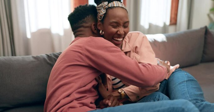 Man, woman and tickle on sofa in home with laugh, smile and joy for playing in living room for fun. African people, married and relax with spouse with love in relationship for bond, trust and care