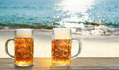Two glasses of beer on a summer day on the beach