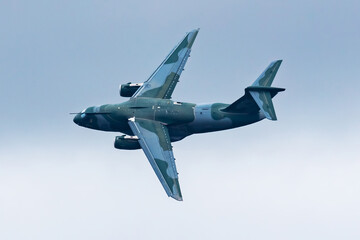 Fototapeta na wymiar Untitled military transport plane at air base. Airport and airfield. Air force and army flight operation. Aviation and aircraft. Air lift. Military industry. Fly and flying.