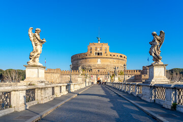 Dome of the Castel Sant Angelo in Rome, seen through a bridge adorned by statues over the Tiber river. - obrazy, fototapety, plakaty