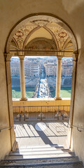 view of the bridge and the river Tiber through an arched balcony belonging to the castle of sant...