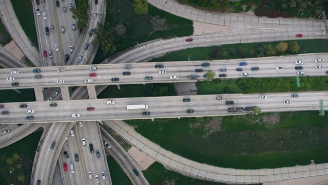 Overhead Dolly out Aerial View of Traffic in Interstate 110 and 10 Highway Full of Cars and Trucks. Famous Freeway interchange in Downtown Los Angeles, California. United States. 