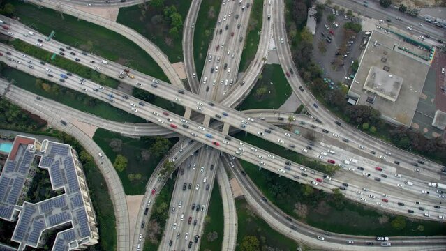 Overhead Aerial View of Traffic in Interstate 110 and 10 Highway Full of Cars and Trucks. Transportation. Famous Freeway interchange in Downtown Los Angeles, California. United States. 