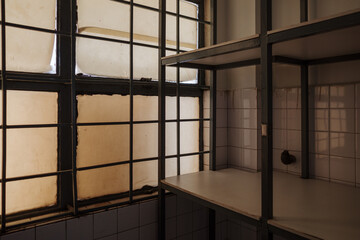 Aged Industrial Interior with Grid Windows and Shelving.