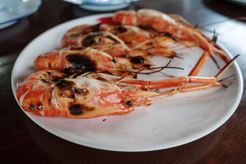 Grilled giant river prawn, famous local Thai luxury fine dining menu in Thailand, serve on white plate dish.