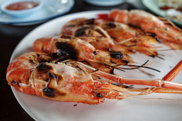 Grilled giant river prawn, famous local Thai luxury fine dining menu in Thailand, serve on white plate dish.