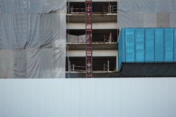 Exterior view of construction building facade, The Mesh of Progress at a Building Construction Site.