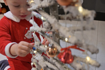 child playing with christmas tree