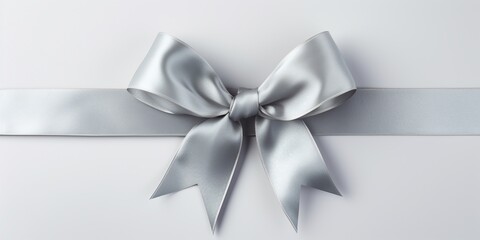 Silver gray shiny luxury gift ribbon with bow, Christmas, birthday, Valentine's Day, Anniversary Gift packing, isolated on grey background