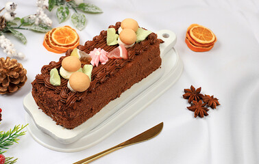 Homemade winter dessert, stollen or strudel with sweet cream filling, nuts, cinnamon and poppy seeds. Concept for holiday bakery, seasonal treats and cafe advertising,