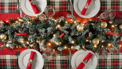 Family preparing the table set for Christmas dinner 