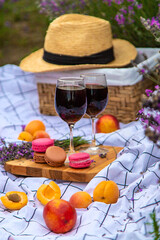 A woman drinks wine in a lavender field. Selective focus.