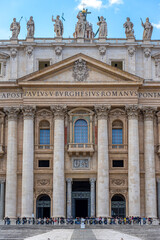 Fototapeta na wymiar symmetrically framed front and central facade of the basilica of st peter in the vatican with details of the columns and windows