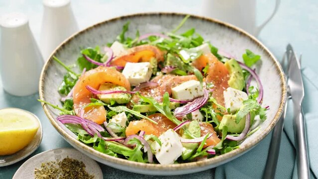 Salmon salad. Fresh salad with salted salmon arugula feta cheese and red onion