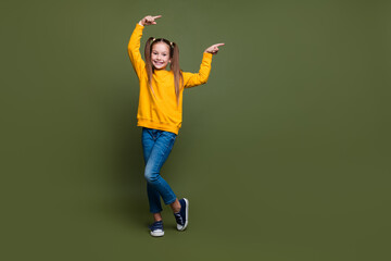 Full size photo of cute schoolgirl with ponytails wear yellow pullover indicating at promo empty...
